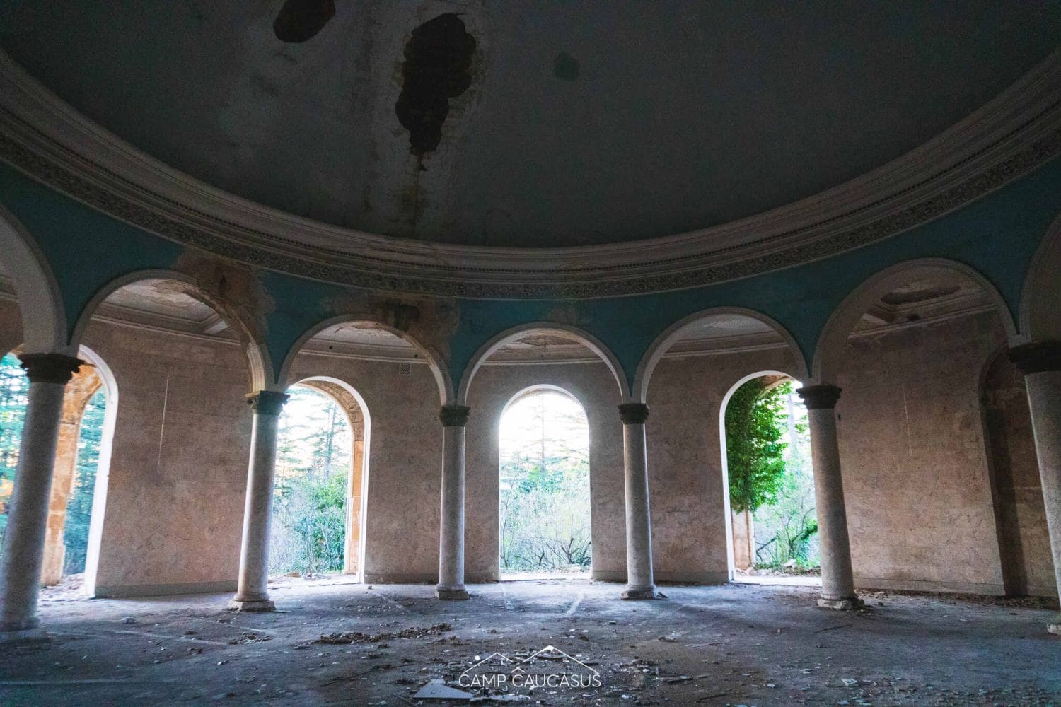 abandoned Soviet-era sanatorium in Tskaltubo, Georgia, showcasing elegant architectural elements and the haunting beauty of forgotten spaces