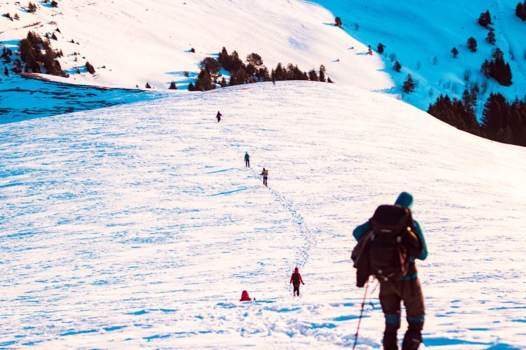hikers walking borjomi hiking trail on snowshoe, Georgia, winter tour of camp caucasus