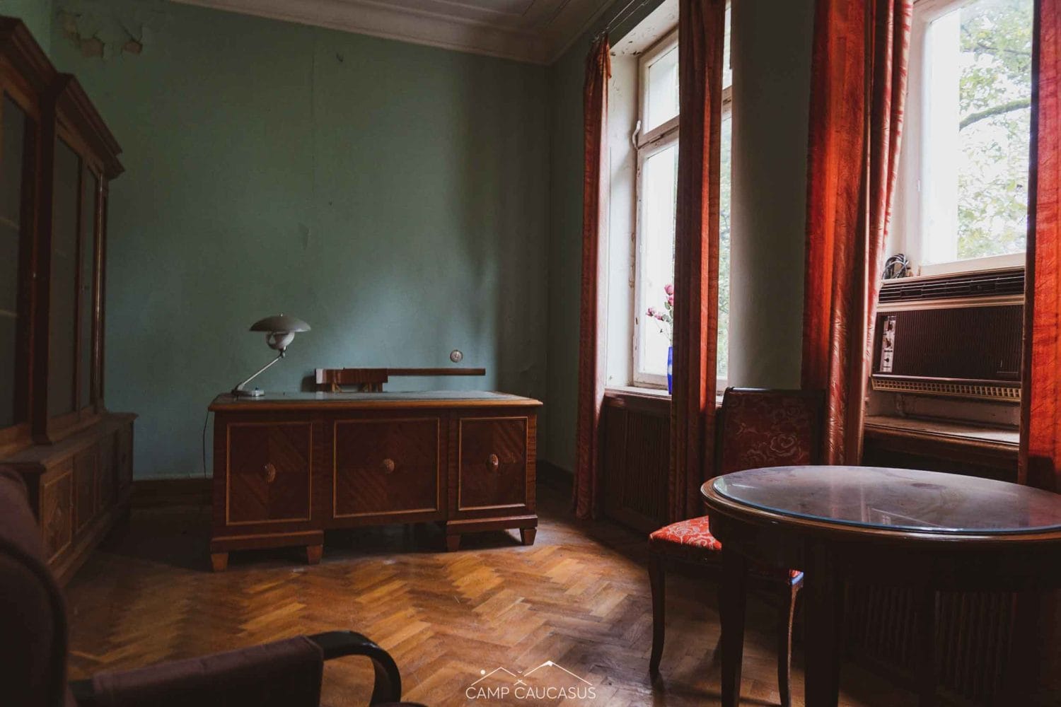 Interior of a deserted sanatorium room in Tskaltubo, Georgia, featuring aged furniture and historical artifacts left behind from the Soviet era, ideal for urban exploration photography