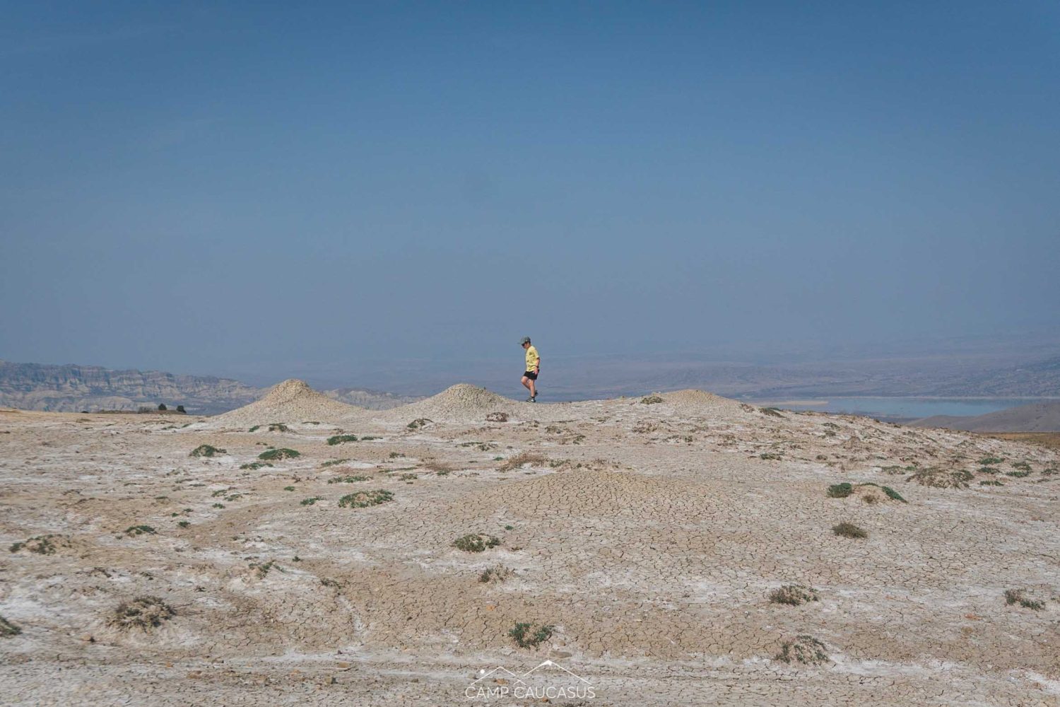Hiker walking across volcanic plain in Vashlovani, Georgia