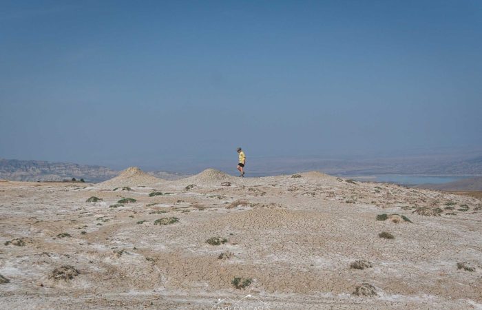 Hiker walking across volcanic plain in Vashlovani, Georgia