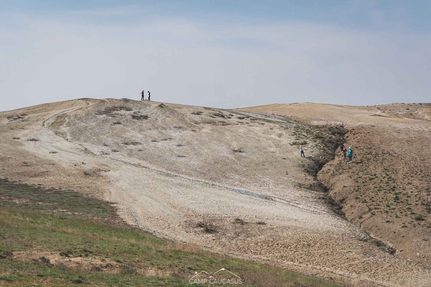 Hikers exploring Takhti-Tepha mud volcano hills in Vashlovani National Park, Georgia