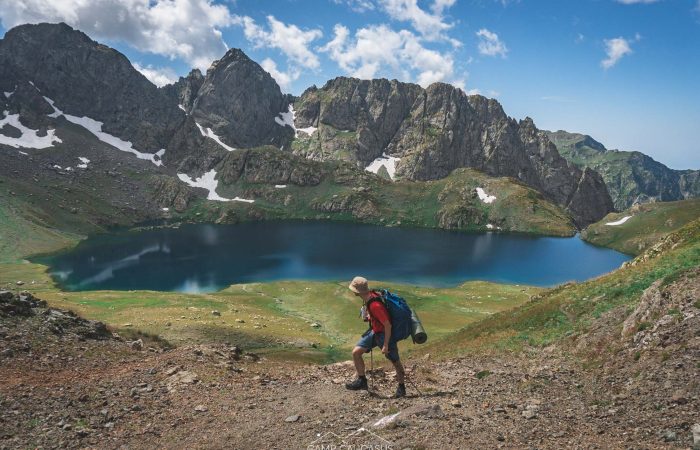 Solo hiker standing near Silver Lake on Tobavarchkhili wild trail