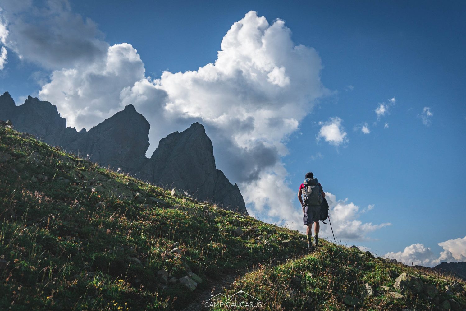 Hiker walking through rocky peaks on Tobavarchkhili trail, Georgia