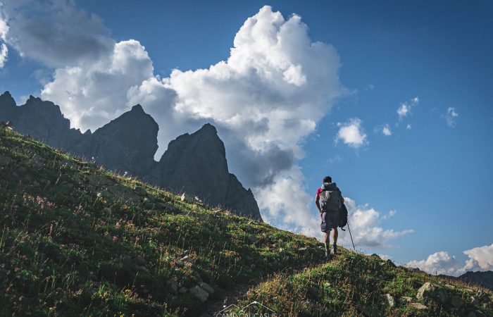 Hiker walking through rocky peaks on Tobavarchkhili trail, Georgia