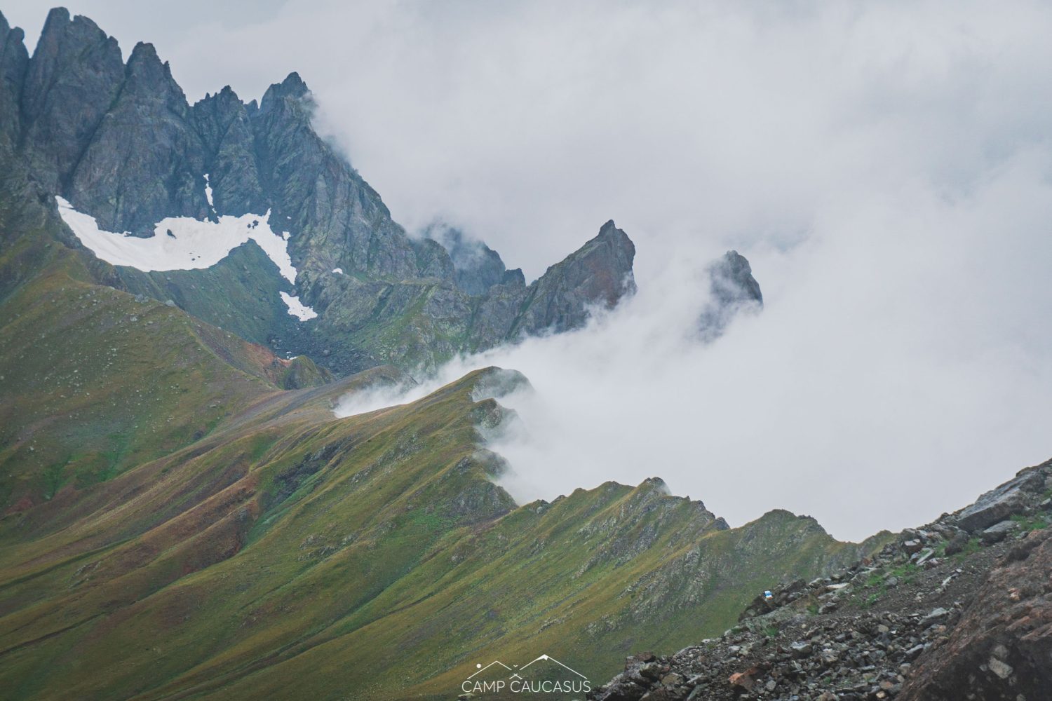 Cloud-covered Tobavarchkhili mountain peaks along hiking trail