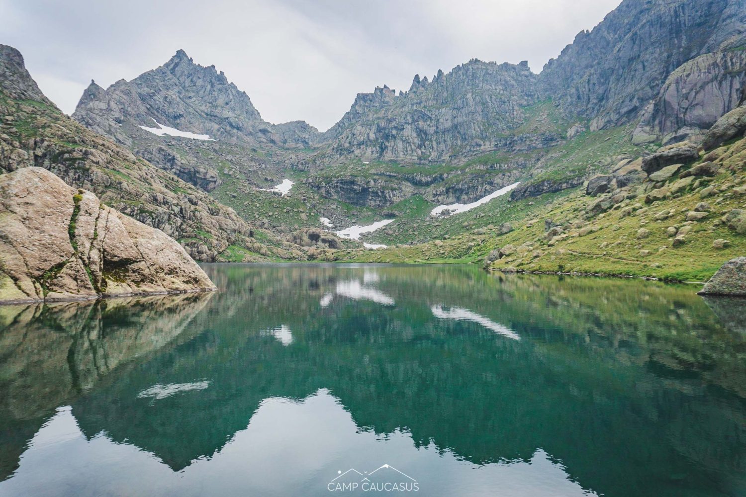 Mirror-like alpine lake along Tobavarchkhili trek in the Caucasus