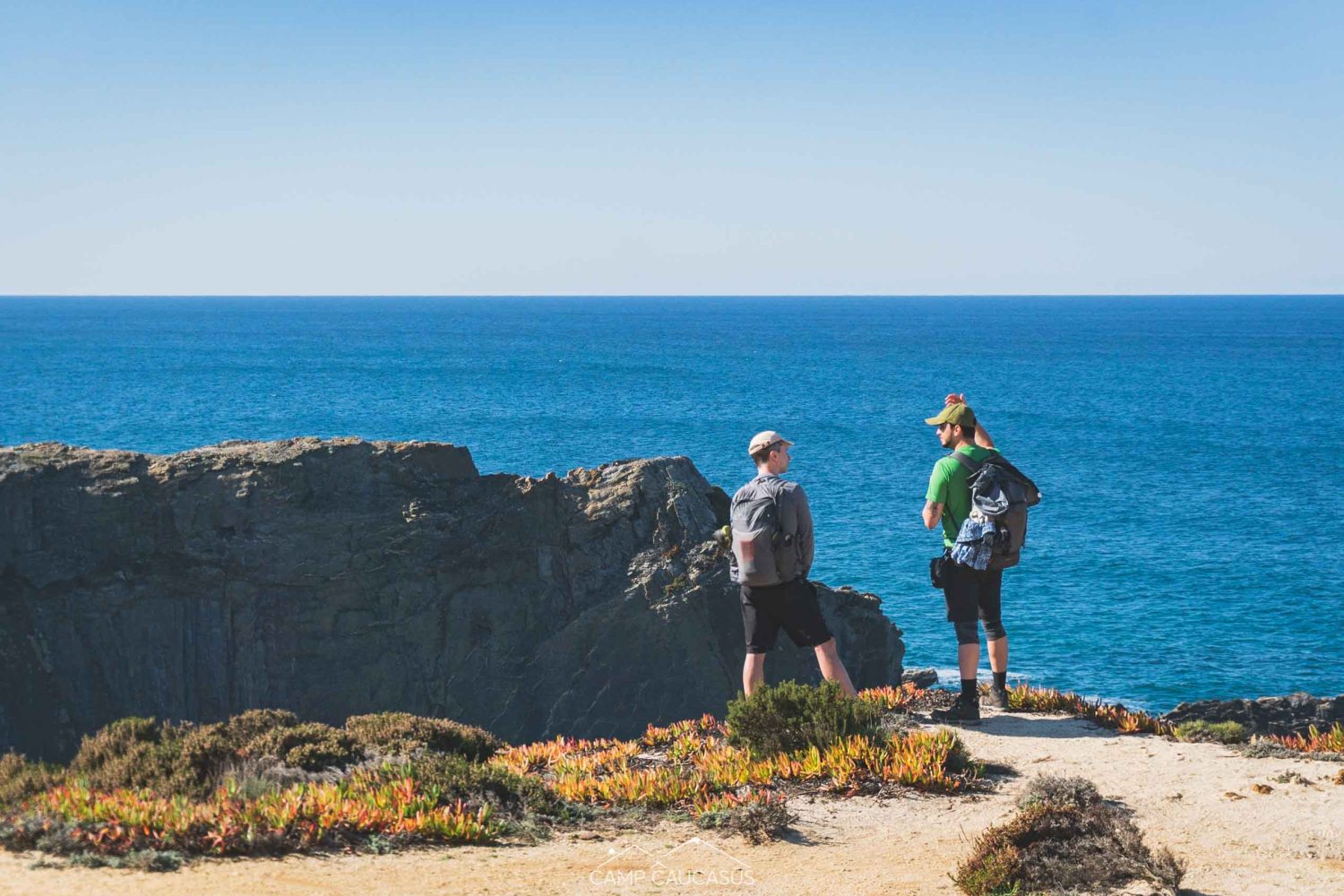 Hikers walking along the Fisherman’s Trail near Zambujeira do Mar, Portugal.
