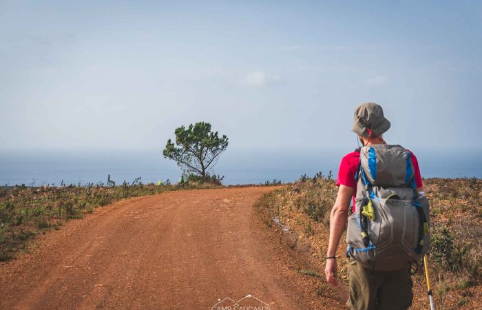 Hiker walking along the Fisherman’s Trail near Carrapateira, Algarve, Portugal.